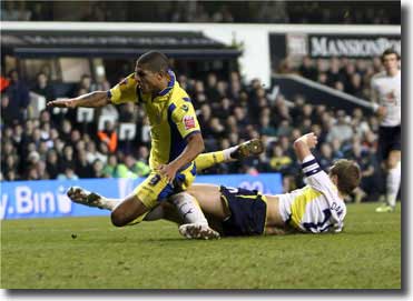 Jermaine Beckford goes down under the late challenge by Spurs’ Michael Dawson that brought the vital late penalty