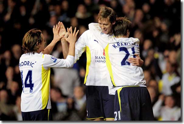 Peter Crouch is congratulated by teammates Luka Modric and Niko Kranjcar after opening the scoring