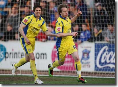 Leigh Bromby shows his delight as Luciano Becchio wheels away after opening the scoring at Brunton Park