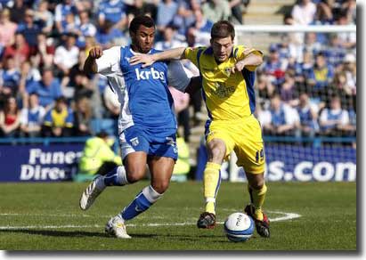 Ben Parker tangles with Gillingham's Rene Howe - after a decent performance as sub at Priestfield, the left-back was recalled to start the game against MK Dons