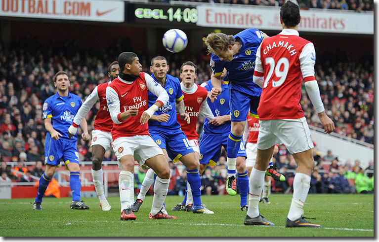 Luciano Becchio sends a header at goal - Szczesny pulled off a remarkable reflex save to parry it away