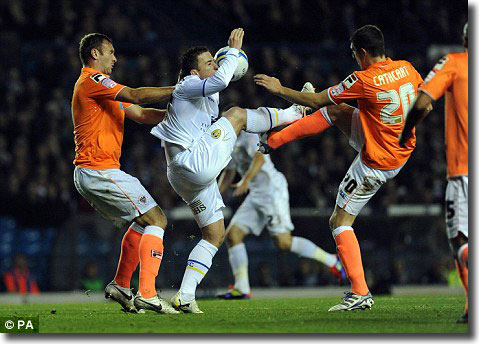 Ross McCormack is outnumbered by Blackpool's Ian Evatt and Craig Cathcart