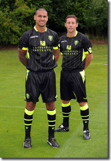 Paddy Kisnorbo and new midfielder Michael Brown model the 2011/12 away kt