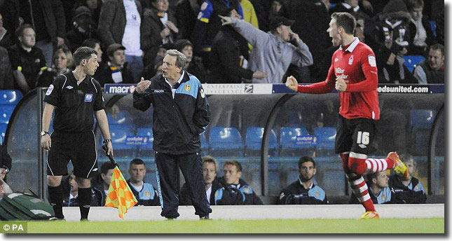 The assistant referee gets the edge of Warnock's tongue as Forest celebrate their seventh goal