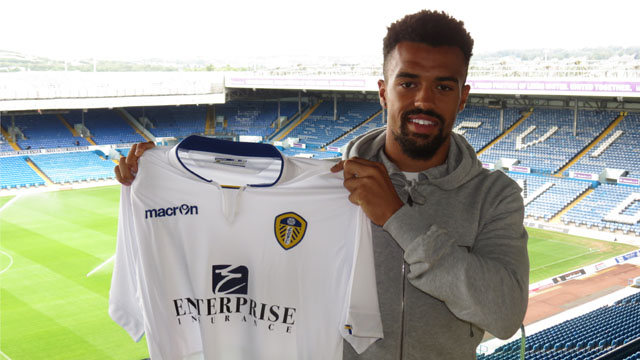 Nicky Ajose shows off his Leeds shirt after signing from Peterborough in August 2014