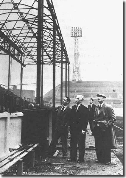 Raich Carter and assistant trainer Willis Edwards survey the damage caused by the September 1956 fire, along with secretary Mr H Lunn