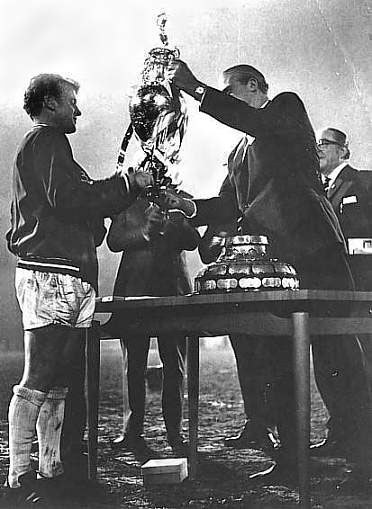 Billy Bremner being presented with the trophy for the League title win in 1969