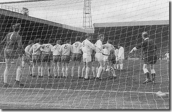 Referee Ray Tinkler struggles in vain to get the Albion wall to retreat the required ten yards