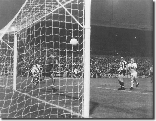 Peter Lorimer fires past Martin to make it 2-0 with Billy Bremner looking on