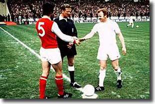 Frank McLintock and Billy Bremner shake hands before the game as they meet referee David Smith