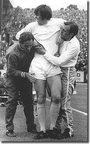 Les Cocker and the Chelsea trainer carry off David Harvey during the opening game of 1972/73 against Chelsea.  Peter Lorimer went in goal and Leeds lost 4-0