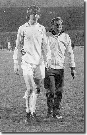 Les Cocker leads off Allan Clarke after the England striker was dismissed at Elland Road