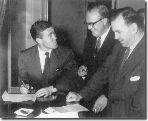 Bobby Collins signs his Everton contract watched by Everton director Jack Sharp and Celtic manager Jimmy McGrory