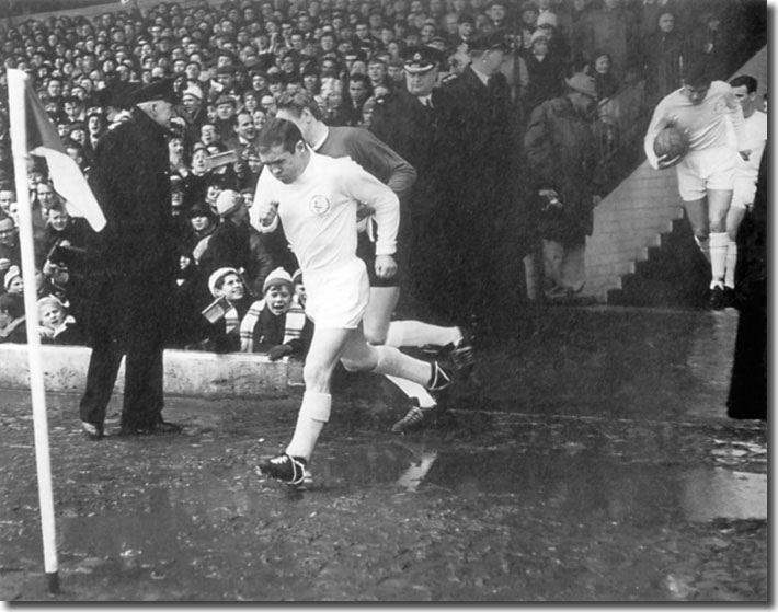 Bobby Collins leads his men out after their return to Division One - the Scot scored the vital winner at Old Trafford
