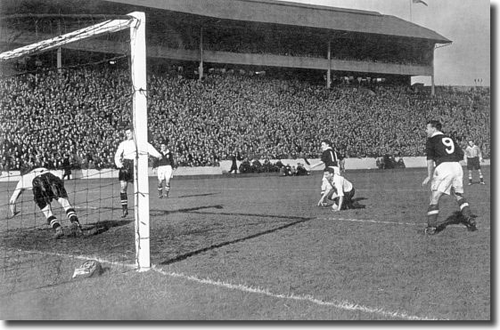 Bobby Collins goes close to a goal for Scotland