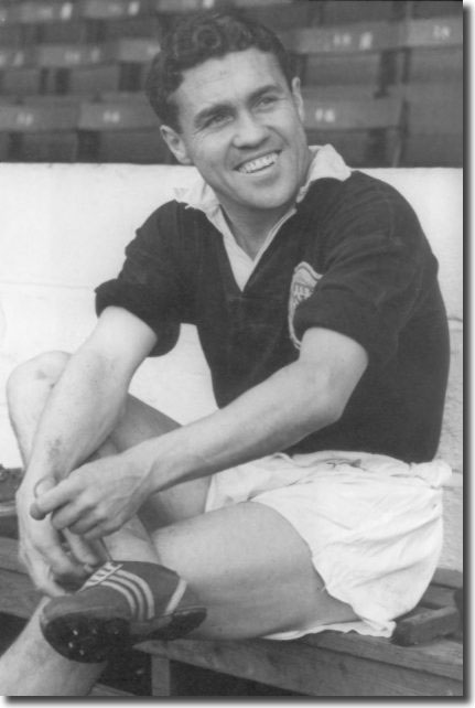 Bobby Collins prepares for a training session before Scotland's clash with England at Wembley in April 1959 - they lost 1-0 - Collins is shown donning the running spikes he used to work on his pace
