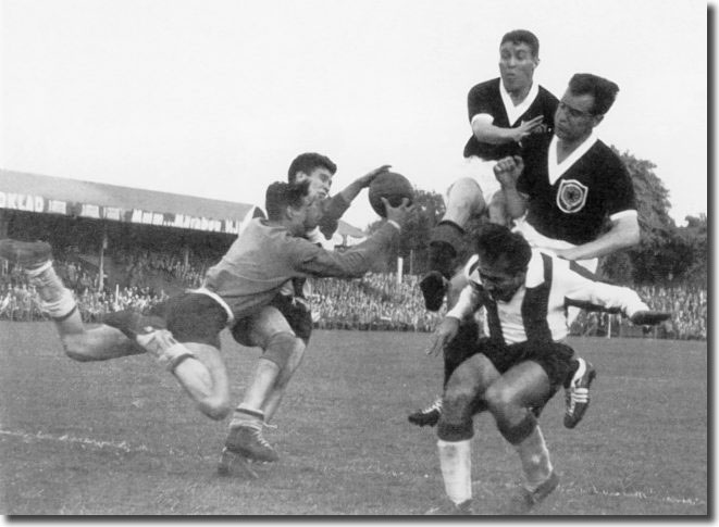Bobby Collins and Willie Fernie pressurise the Paraguay defence during the World Cup finals of 1958 -they couldn't score and defeat virtually ended the Scots' chances of the quarter finals