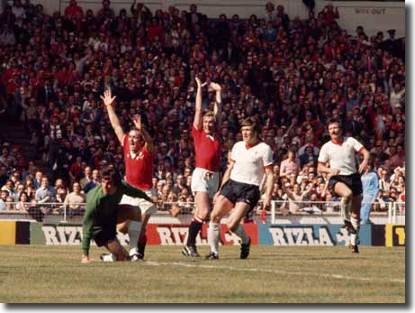 Greenhoff and Macari celebrate a fortunate winner in the Cup final against Liverpool in May 1977