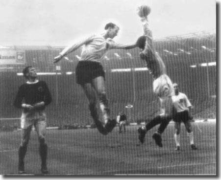 Jack in action during his England debut against Scotland. Billy McNeill and brother Bobby look on as Bill Brown catches this cross