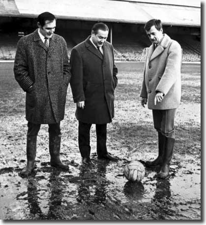 Different day, same old mud at Ninian Park, as Welsh referee Clive Thomas tries to decide whether it is playable