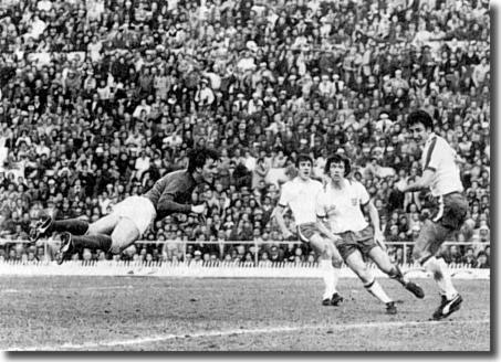 Hughes, Cherry and McFarland are helpless against this header from Italy's Bettega