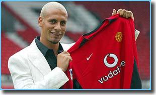 Rio Ferdinand shows off his new Manchester United shirt after completing his move to Old Trafford