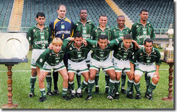 Roque Junior is third from the left in the back row as Palmeiras pose with the Copa do Brasil and Copa Mercosur trophies in 1999