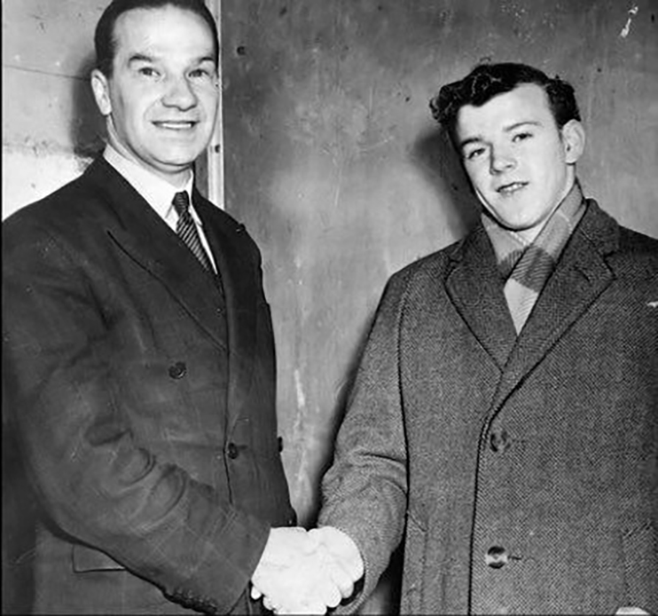 Taylor shakes hands with a very young Billy Bremner